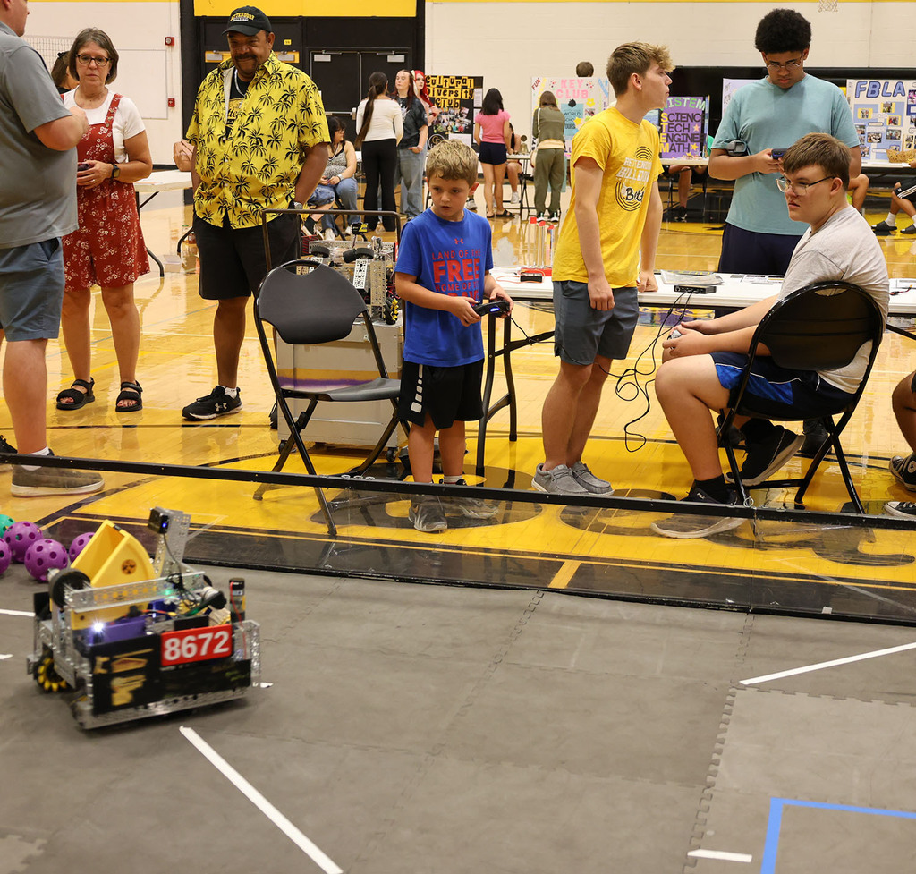 An aspiring high school students trying out the high school robotics team robot