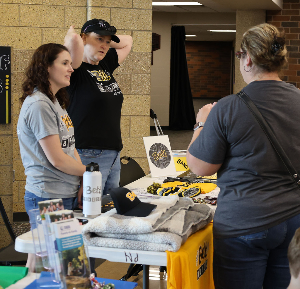 Bett Fine Arts Boosters visiting with a parent