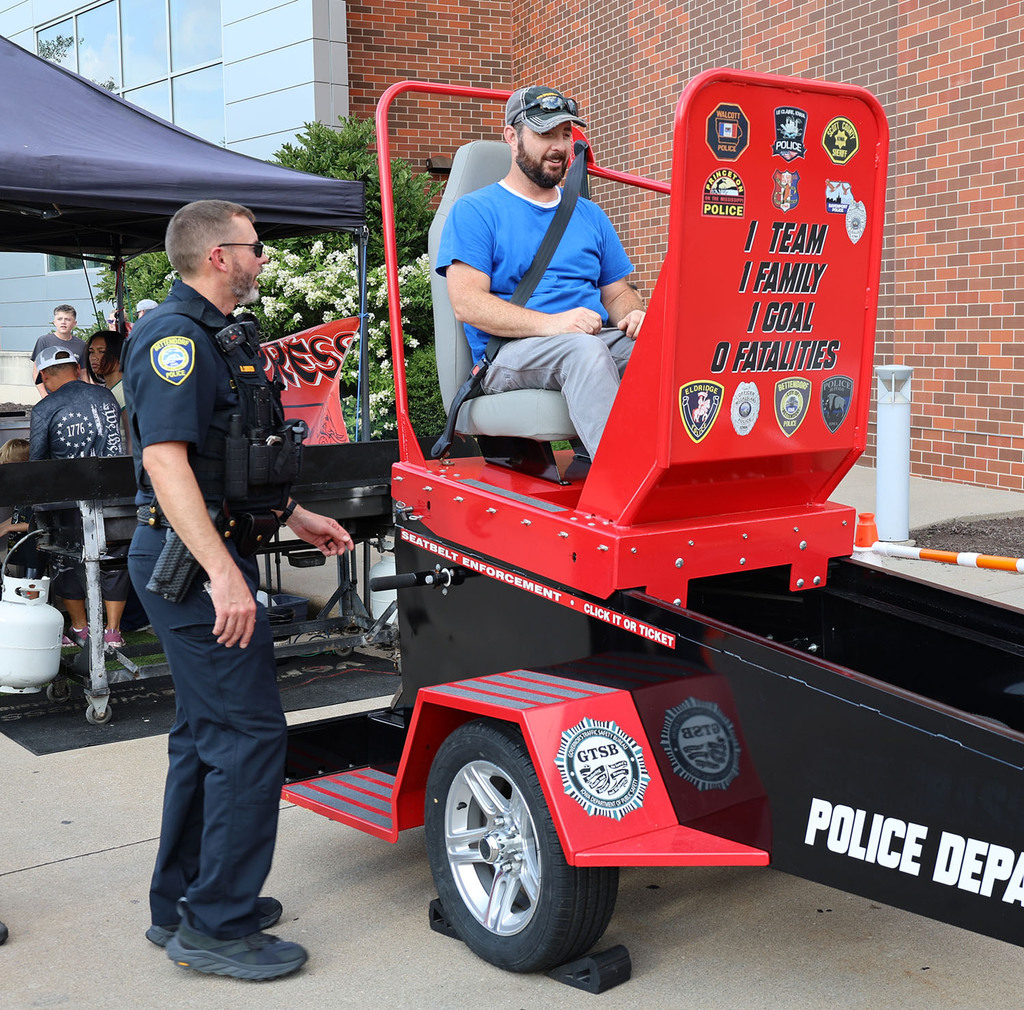A staff member getting ready to be released on the seat belt convincer