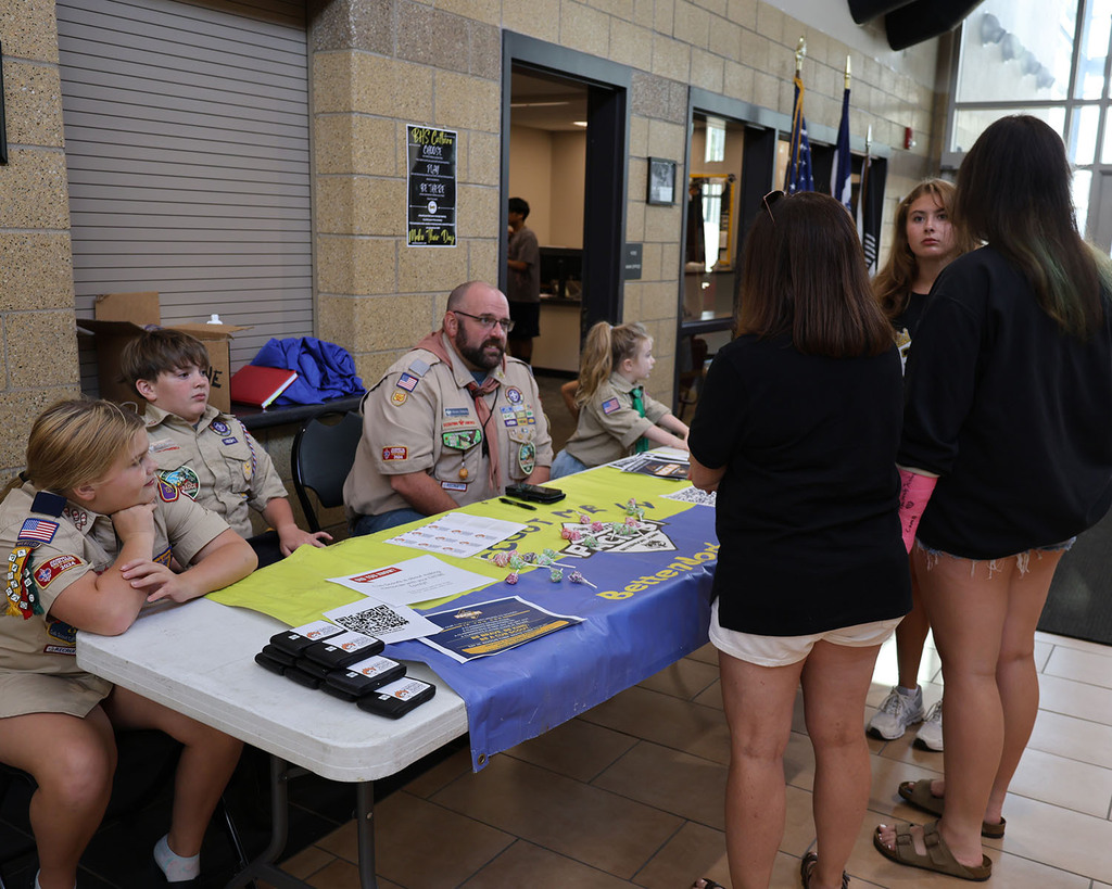 Girls visiting with the Scouting America table