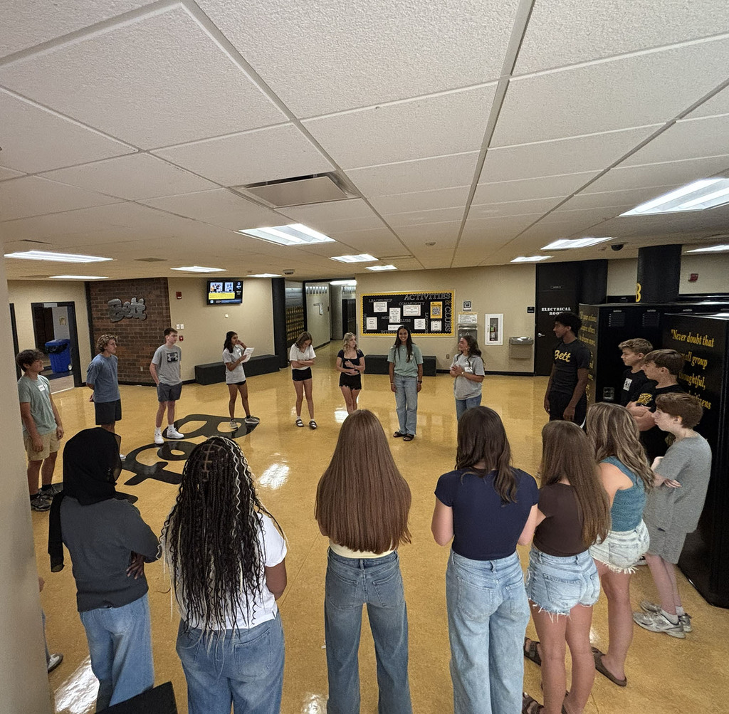 Students in a circle in the E locker bay getting to know each other