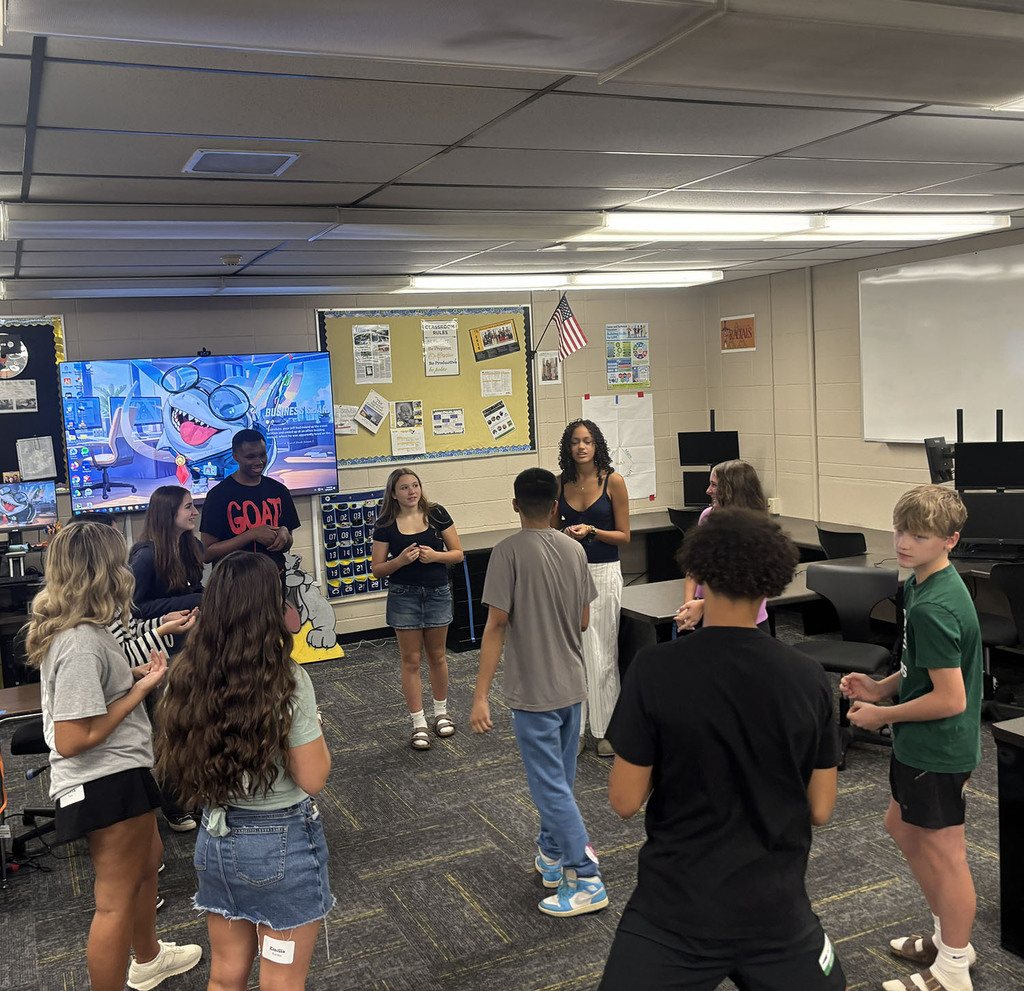 Students in a circle working on an activity in a classroom