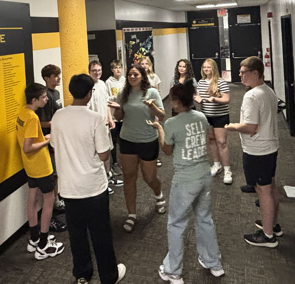 Students working together on small group activities to get to know each other in the hallway