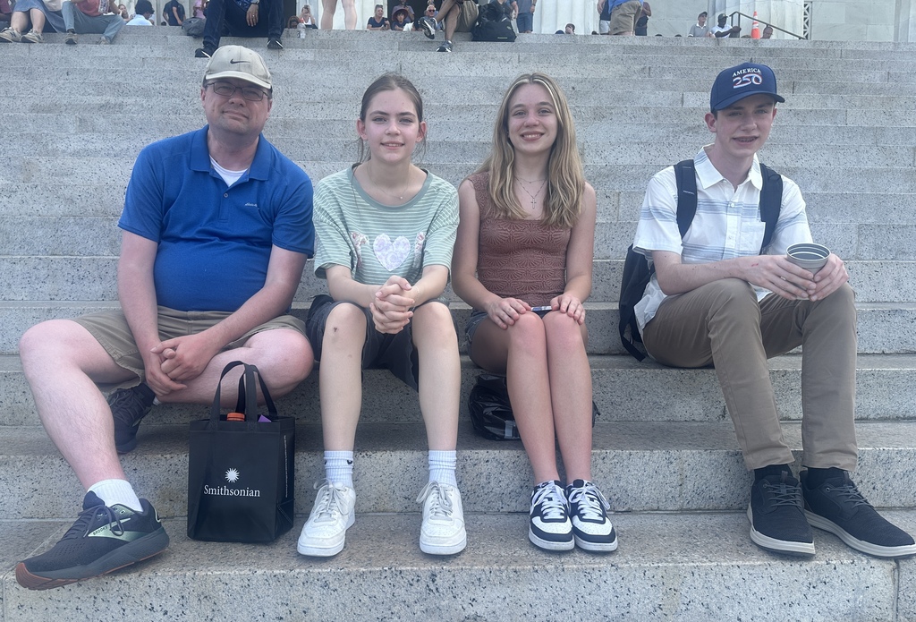 Mr. Ranking and students sitting on the steps of the Lincoln Memorial