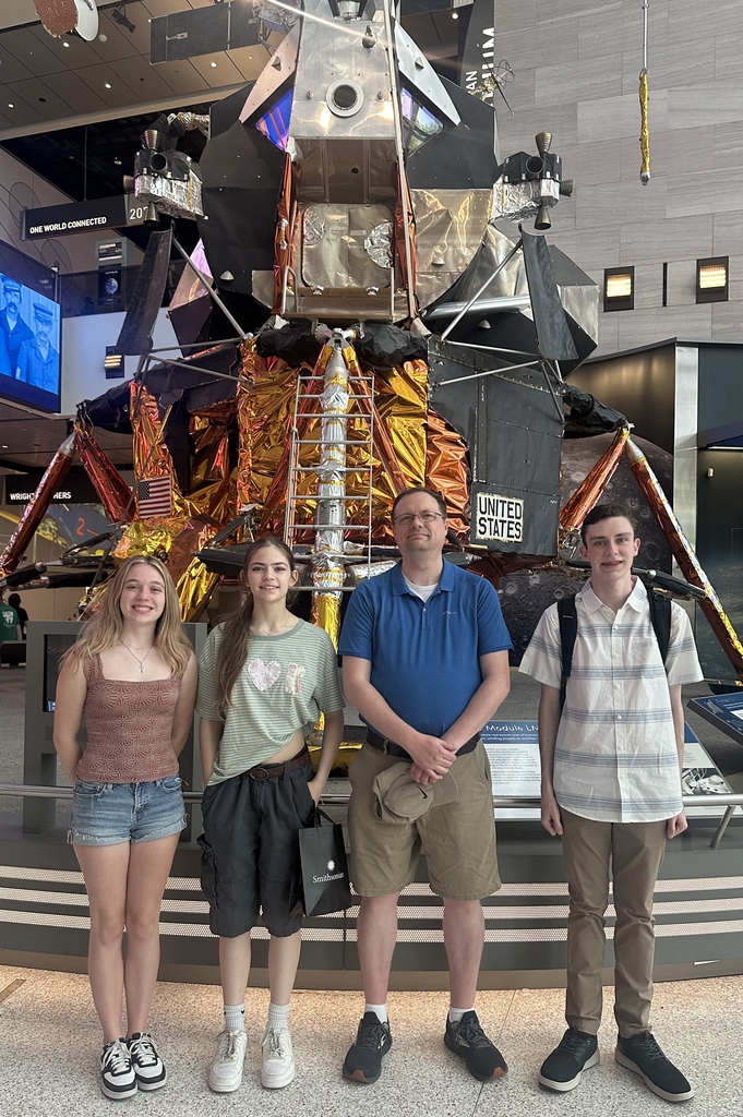Mr Rakin and the students in front of a space lander