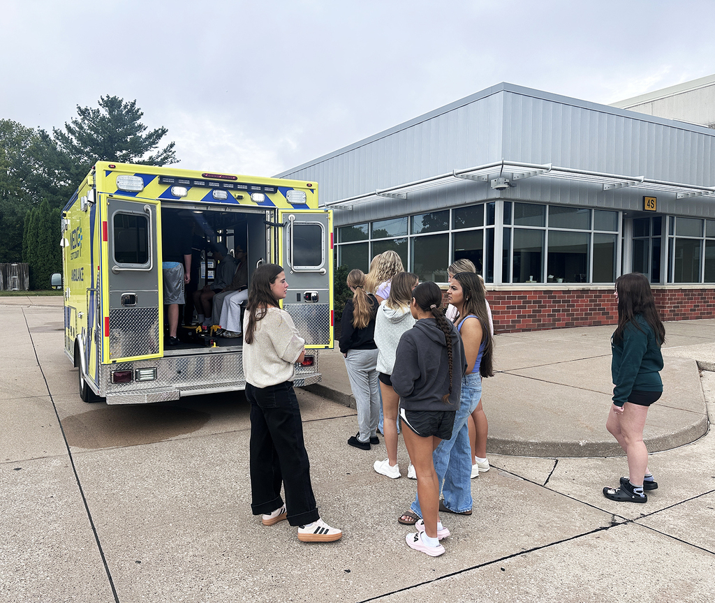 Students waiting for their turn inside the ambulance