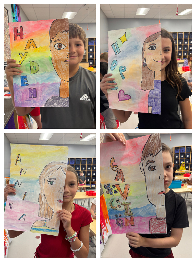 Students holding art work of half of their face with their namesin bubble letters next to the other half of their face