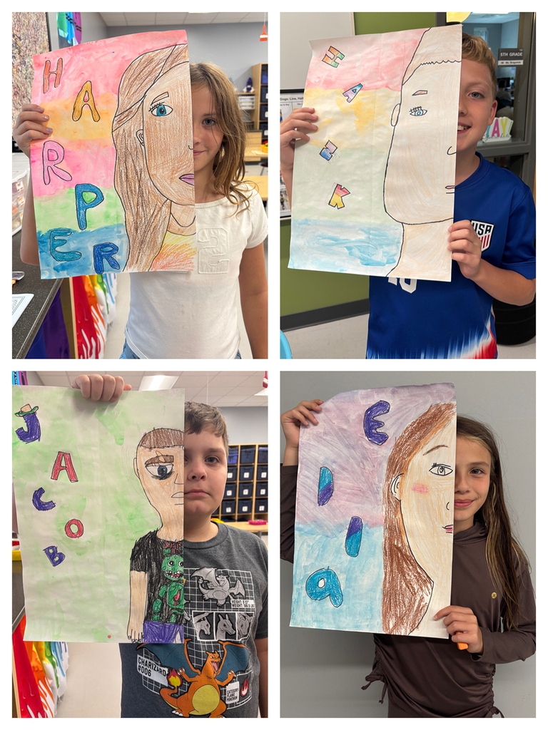 Students holding art work of half of their face with their namesin bubble letters next to the other half of their face