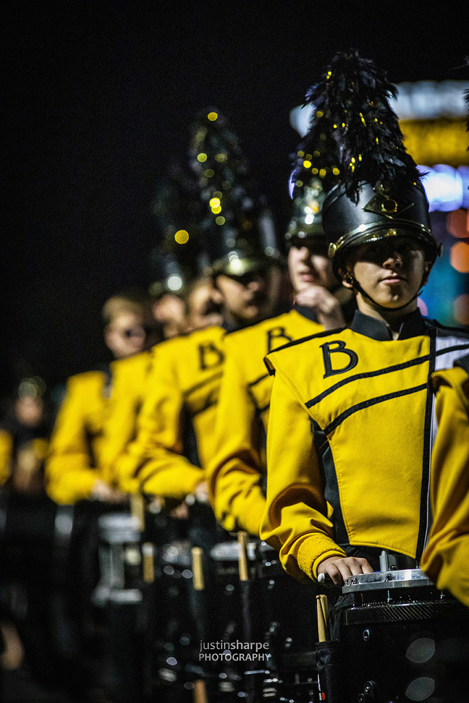 Drummers lined up at a night football game