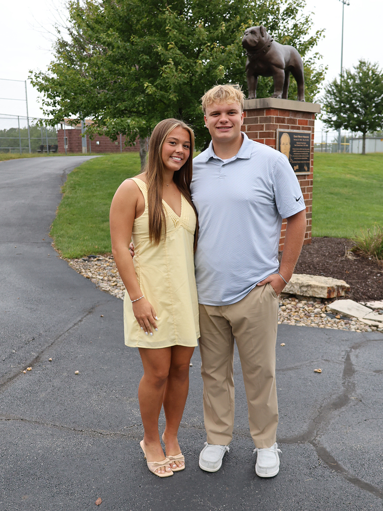 Katelyn Fritz and Gavin Barr in front of the bulldog statue
