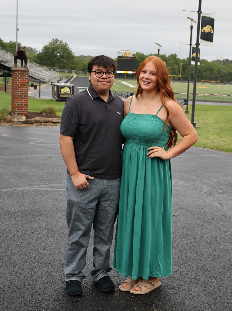 Dyllon Gonzalez and Macy Faust with the football stadium in hte background