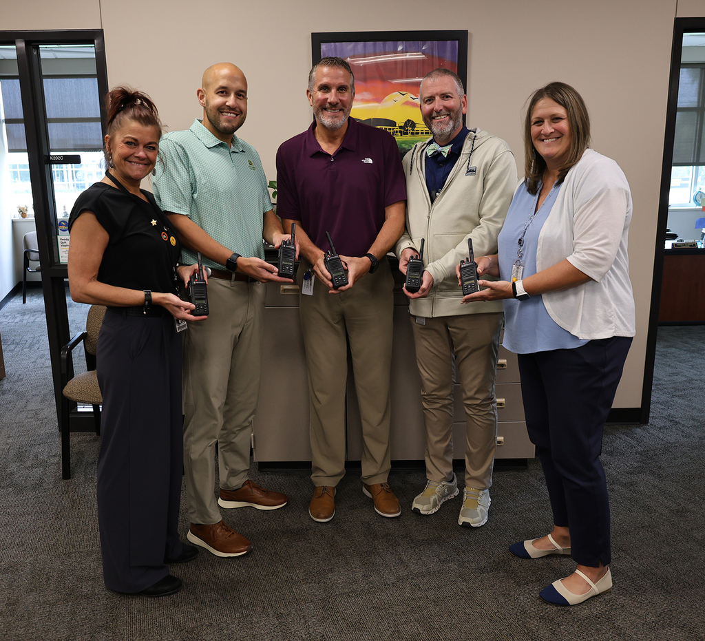 The Bettendorf High School administrative team showing their two-way radios: Jennifer Wikan, Anthony Wittemeyer, Kevin Skillett, Conrad Keibler, and Kristy Cleppe.
