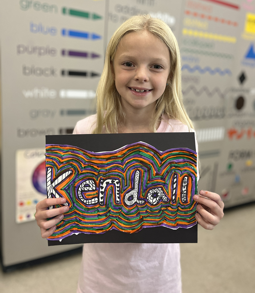Kendall smiling with his art design
