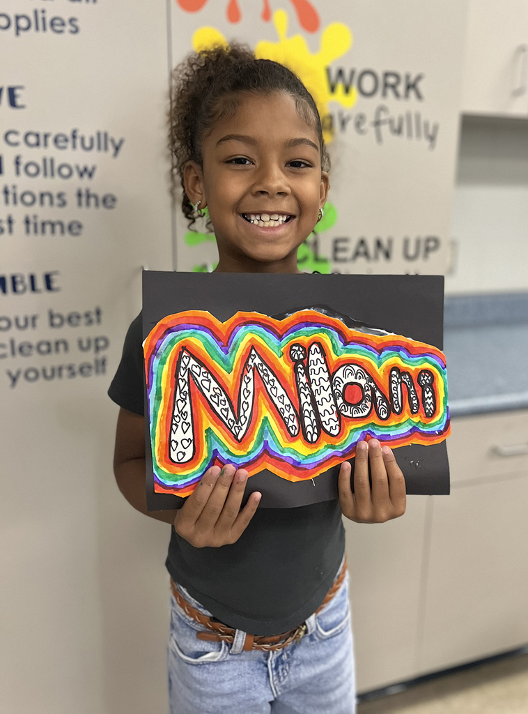 Milani smiling with her art design