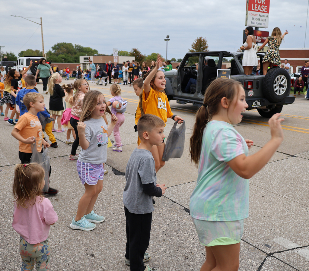 Kids excited to see one of the homecoming court couples in the homecoming parade