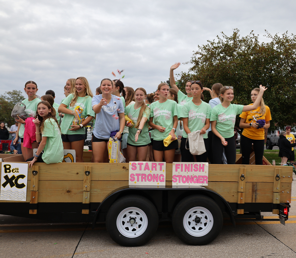 Girls tossing out candy in from the girls cross country float