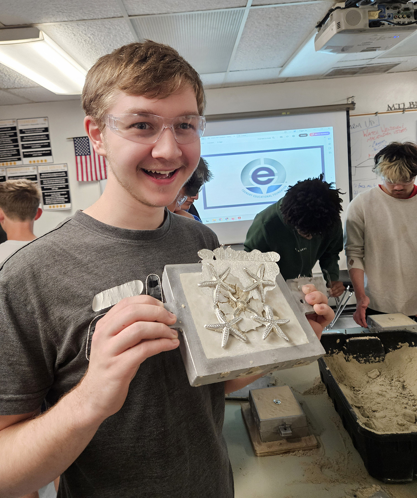 Students showing his casting of four star fish.
