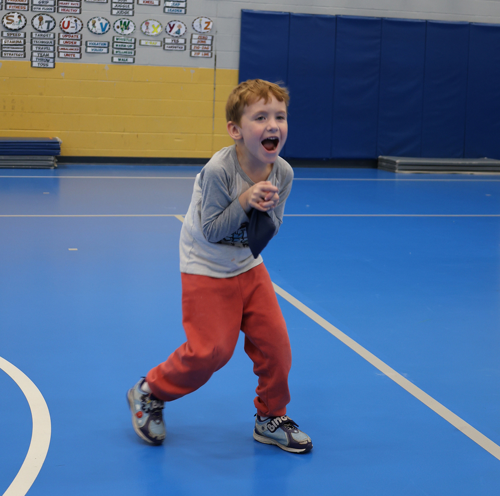 A young student  shows his excitement in catching his bag.