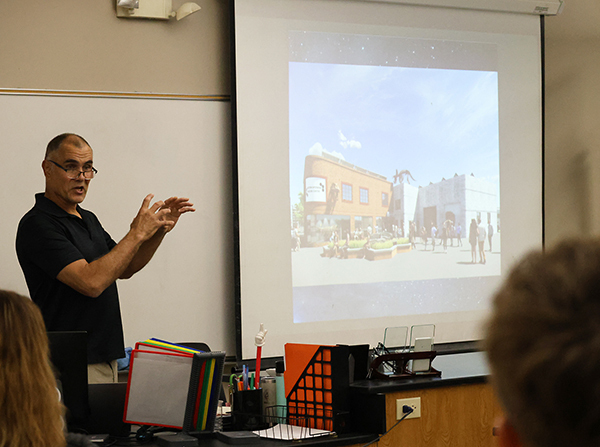 Dr. Ericksen with a image of their proposed science center in Wyoming