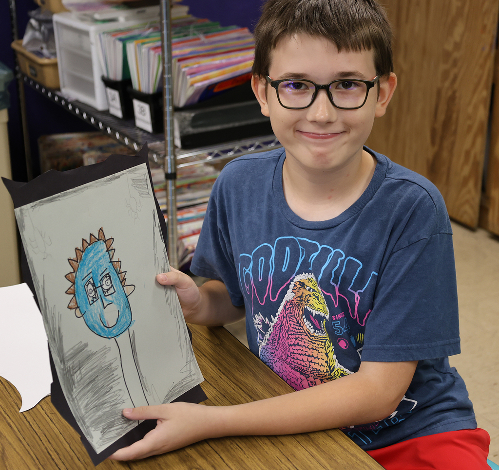 A boy showing his spooky self portrait with a blue face, brown hair, and a very long neck