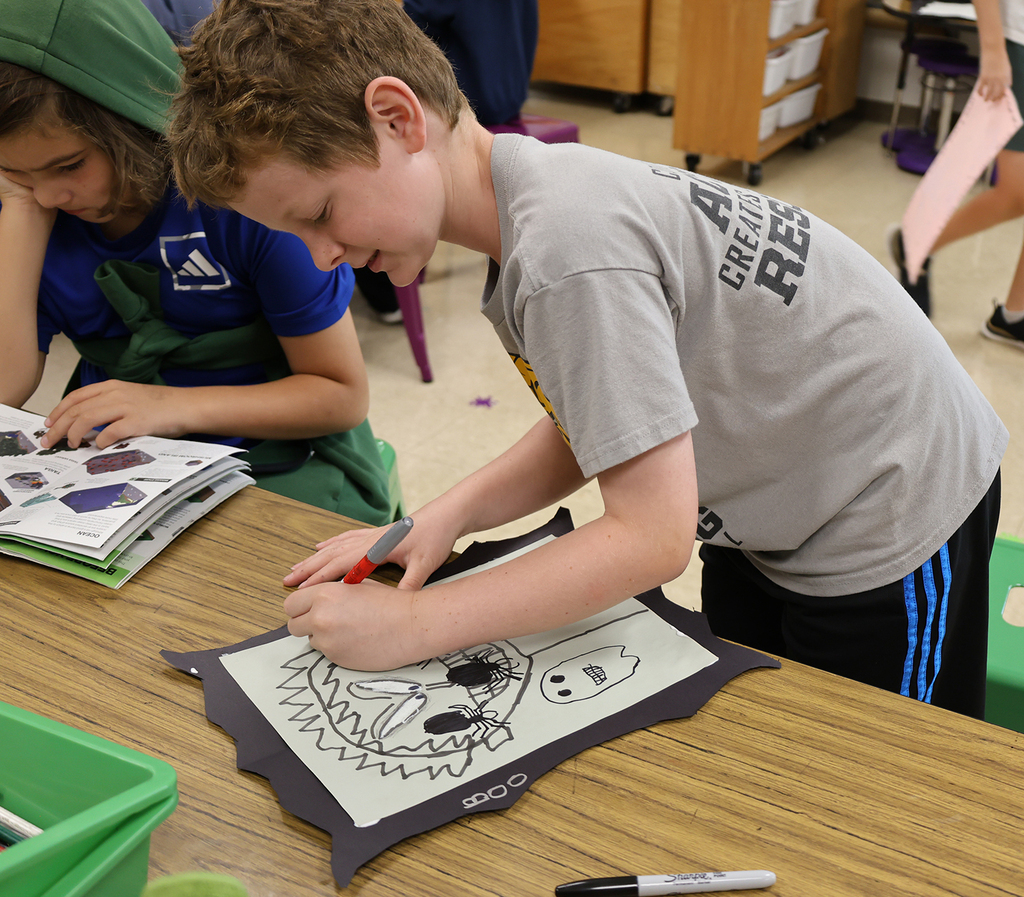 A boy working on his spooky self portrait