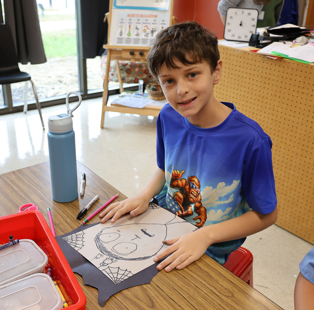 A boy with his portrait with cobwebs and spiders climbing down to his head