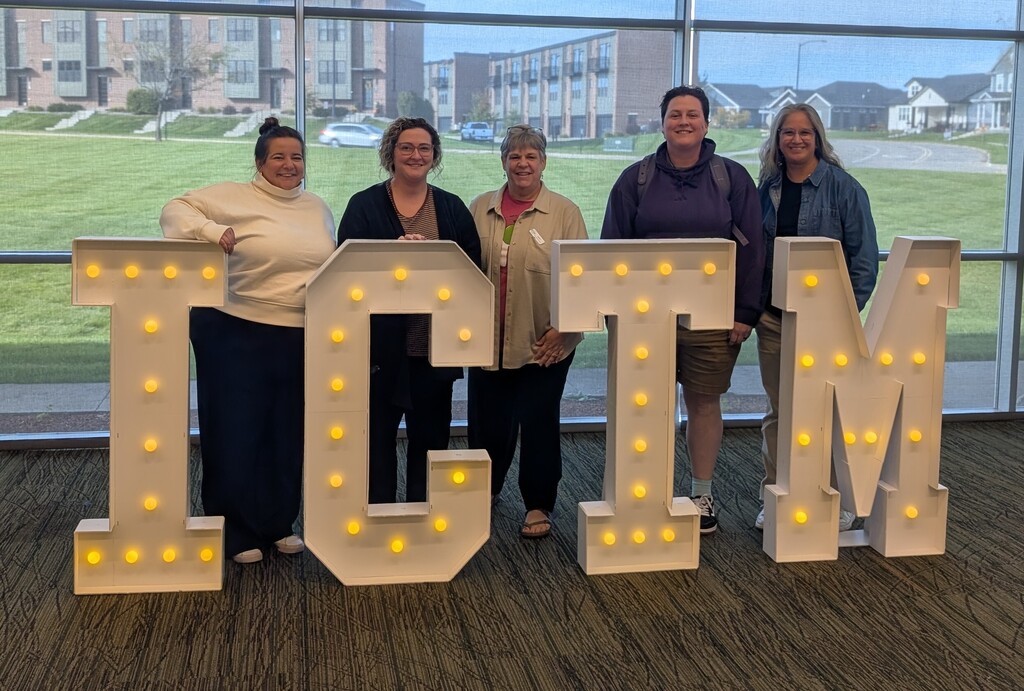 BHS math teachers in back of lit letters ICTM