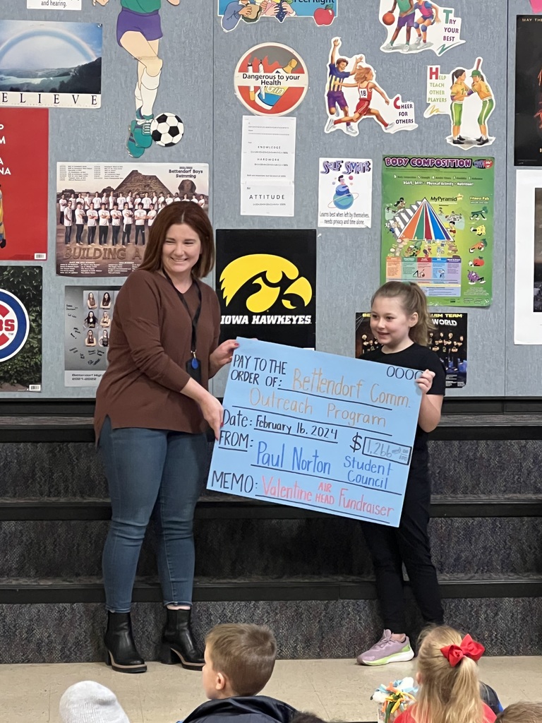 Student council presenting their check to Bett Outreach