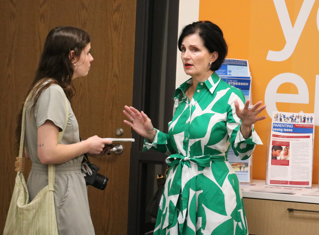 QC Times reporter Olivia Allen talking with  Debi Butler, Director of Brain Health Now