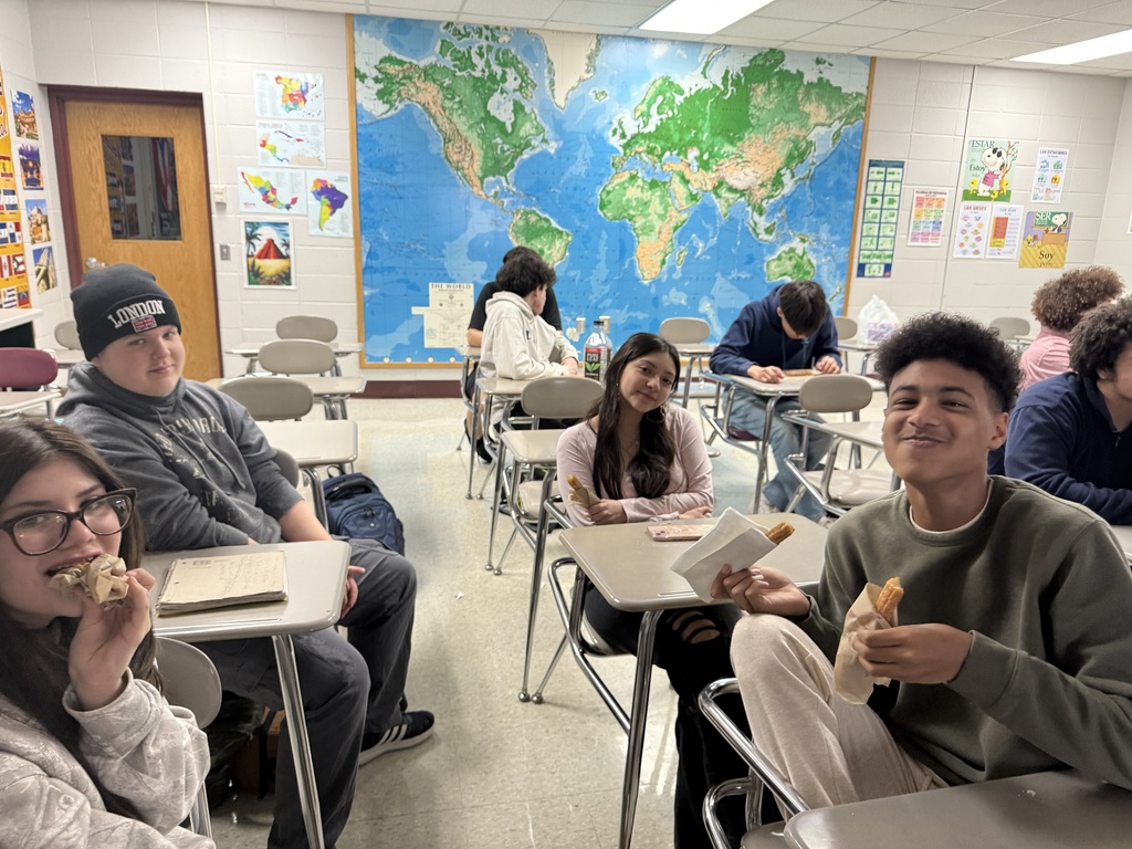 High school age students in a foreign language class consume churros as they learn the ways of creating the cultural dish from professionals of a neighboring restaurant.