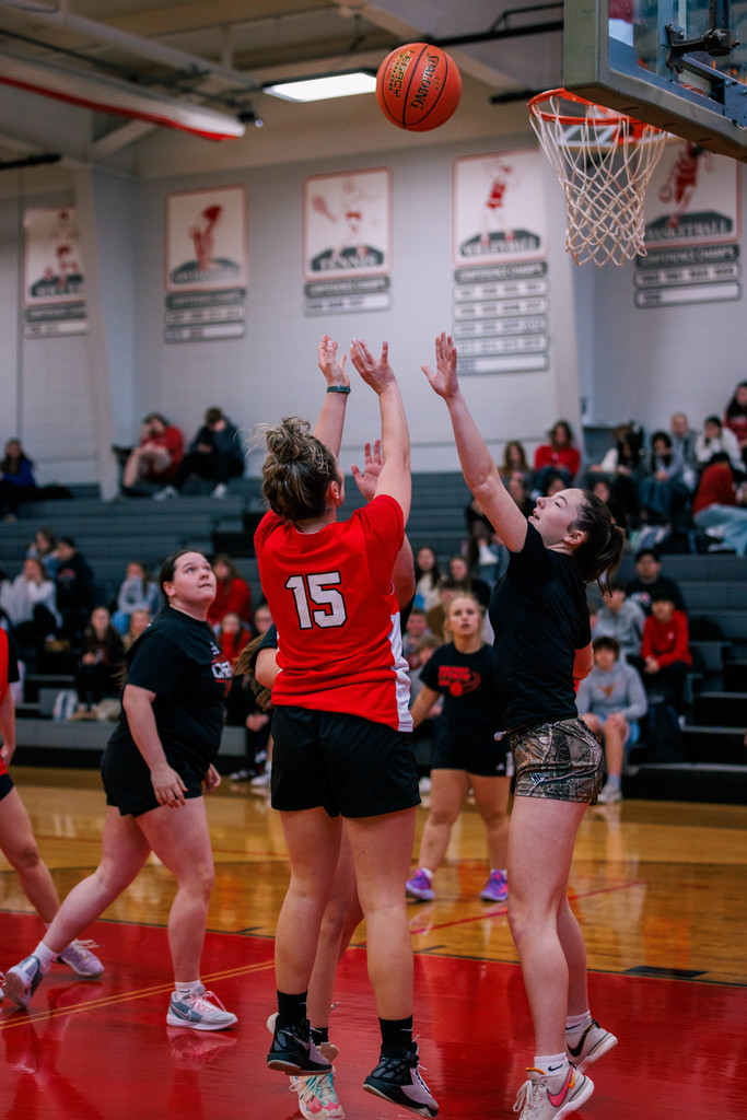High School students participate in a student-staff basketball game, enjoying school spirit.