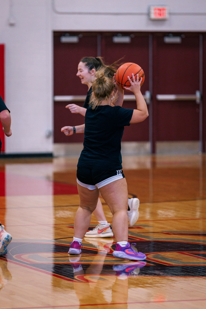 High School students participate in a student-staff basketball game, enjoying school spirit.