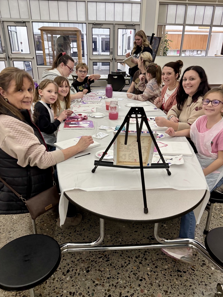 Families posing for a picture .
