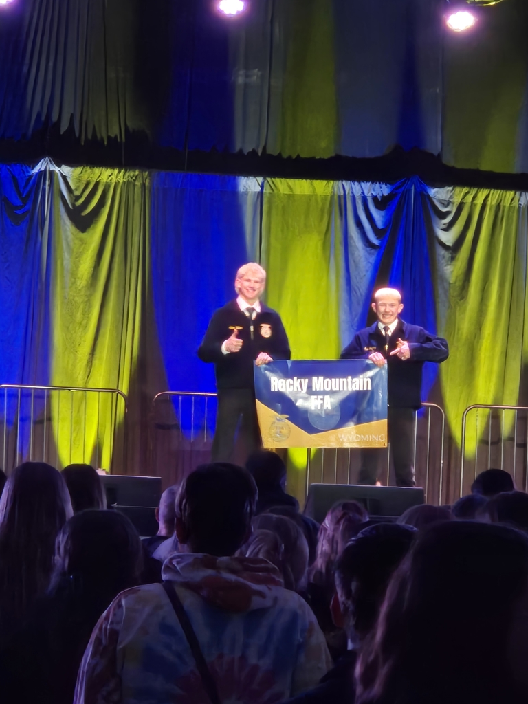 Colten and Sam holding the chapter banner.