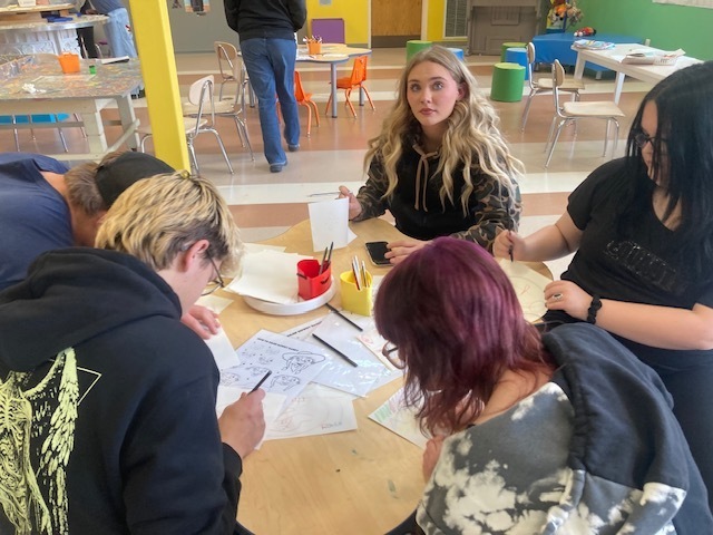 Maddy McCollam participating in a workshop, while visiting the Nicolaysen Art Museum