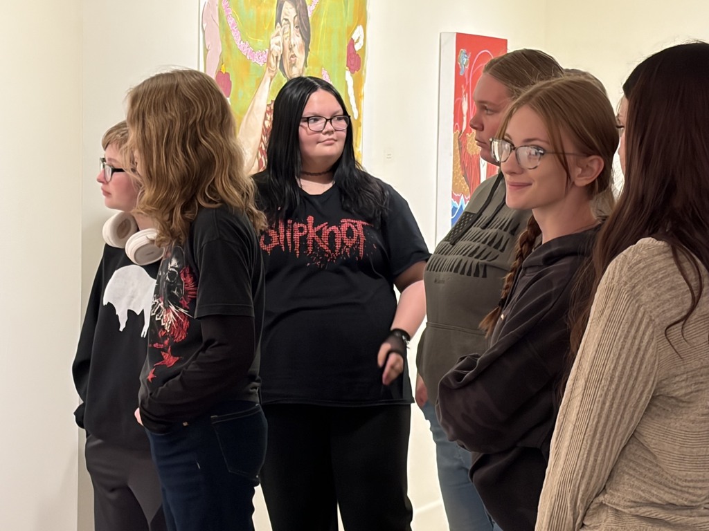 Students viewing artwork in the gallery