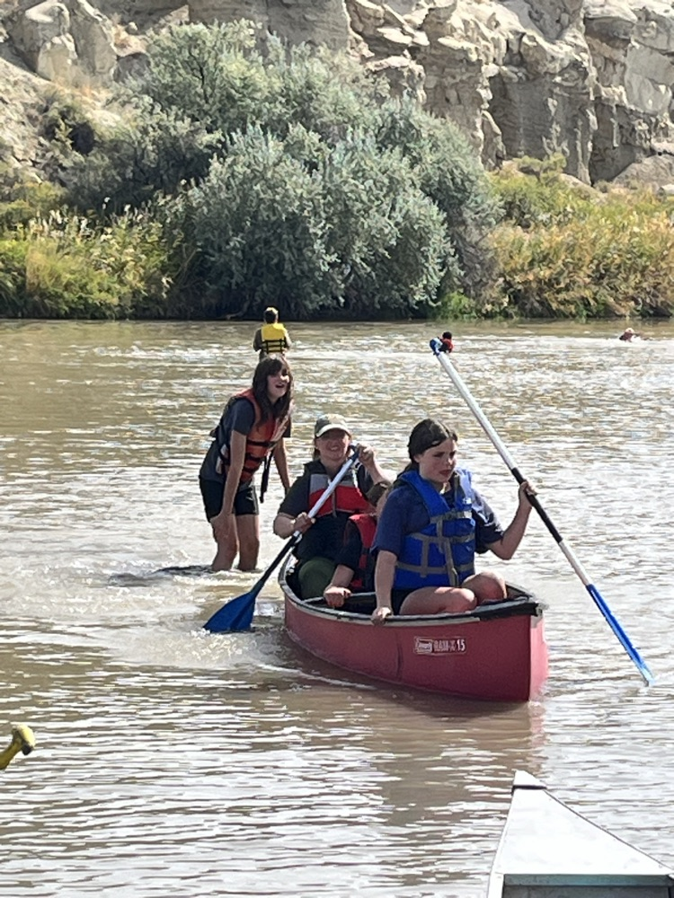 Mrs Stone enjoying her time in canoe with two female students!