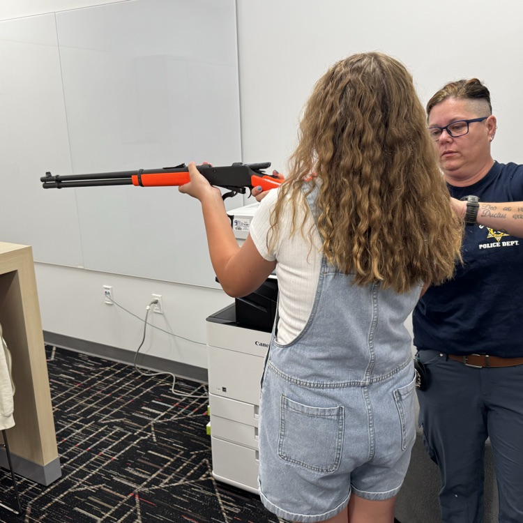 Officer Wiekhorst helps students with action types and safe gun handling