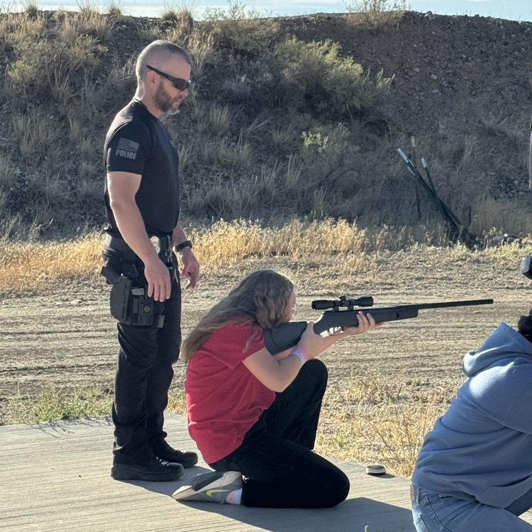 Our police chief spending quality time helping the kids at the range.