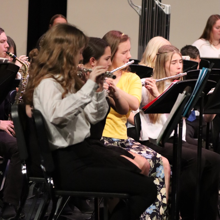 Kelsey plays the flute with the band  