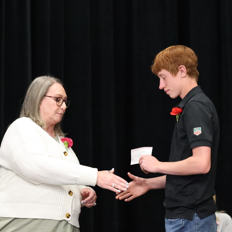 Jack accepting the check from the Booster Club on behalf of his class  