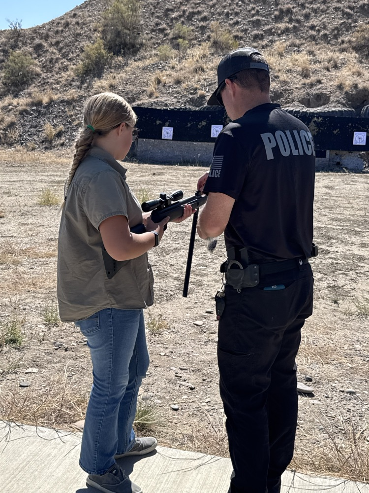 Basin Police helping one of our students at the Gun Range.  