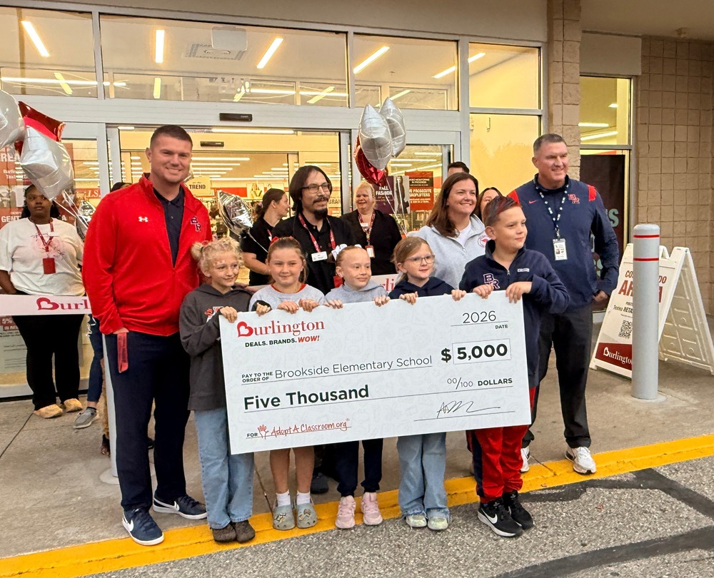 Emily Westman, Ken Ranjel, Tim Haist, and students holding large check from Burlington.