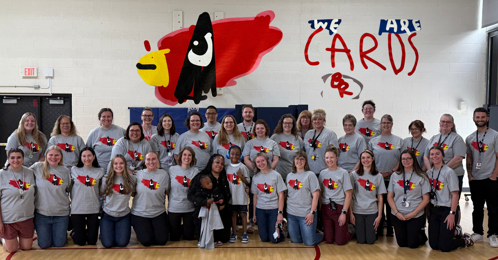 Eastwood Staff with student designed t-shirts made by kindergarten student