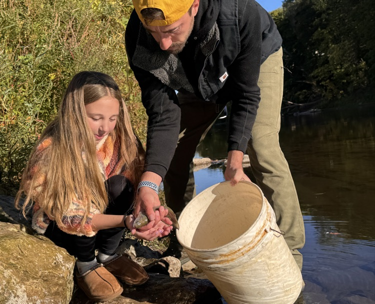 student with trout