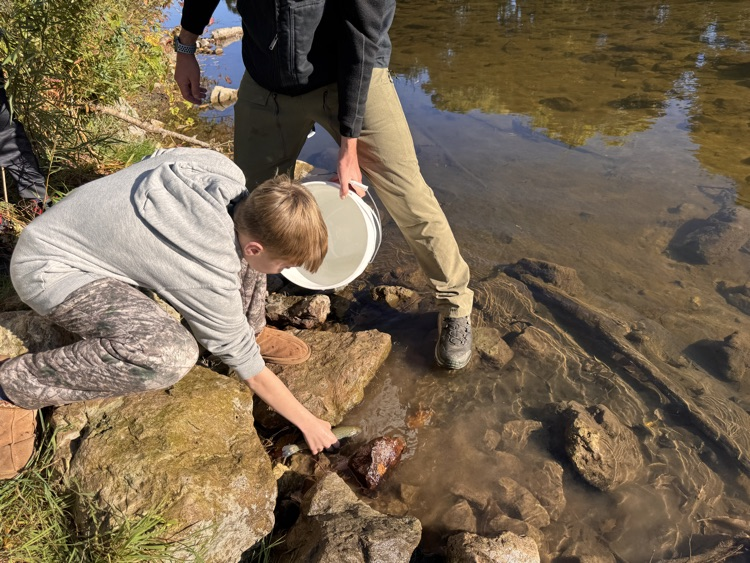 student with trout