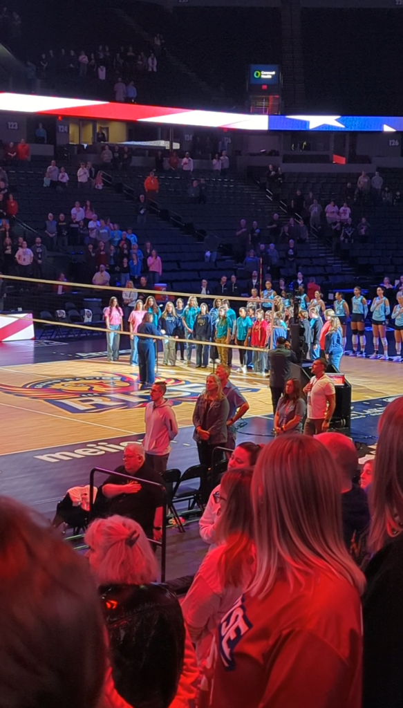 Bella Voce singing the national anthem at a GR Rise volleyball game