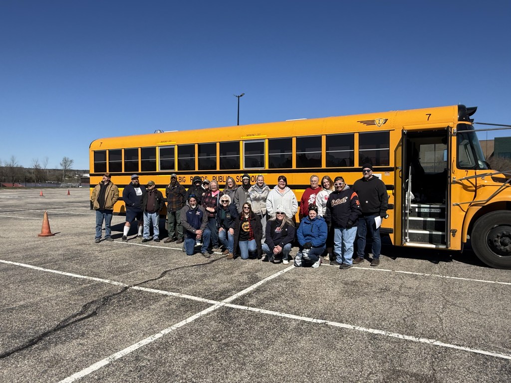 Transportation Department training - staff members in front of a bus
