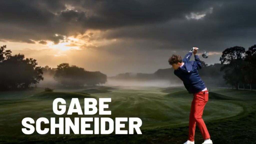 Gabe Schneider - hitting a golf ball with a golf course in the background