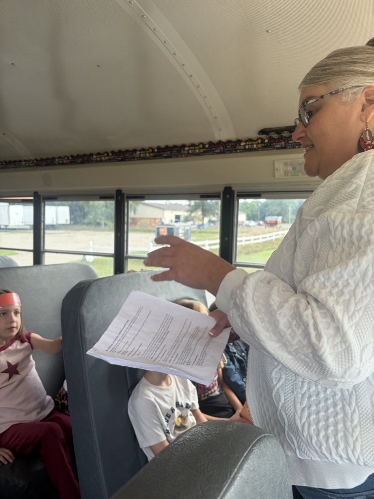 students listening to the bus driver
